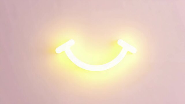 Neon smiley face light on pastel pink wall background  