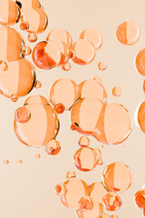 Shiny translucent bubbles in warm peach tones, resembling cosmetic serum or skincare product...