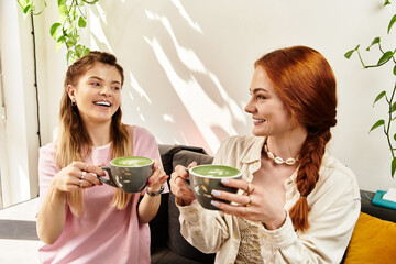 Friends enjoying trendy matcha lattes in a stylish modern cafe filled with greenery