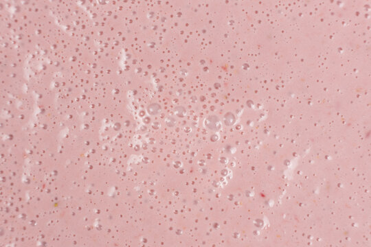 Strawberry milkshake surface, abstract cooking pink background with bubbles.