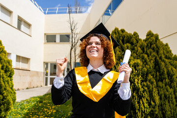 Happy graduate celebrating with diploma in university campus
