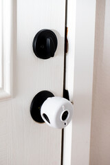 a white safety door knob cover safety for kids feature in our house