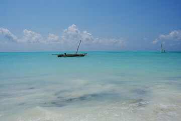 Fishing boat seen from Jambiani beach at Indian Ocean in African Zanzibar island in Tanzania