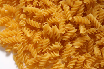 Italian fusilli pasta on white background. Dry pasta as background.