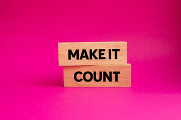 Make it count message written on wooden blocks on pink background. Conceptual make it count symbol. Copy space.