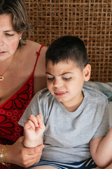 Mother comforting her child with cerebral palsy and intellectual disability