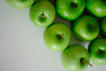 An arrangement of green apples on a clean background. Their bright colors pop and evoke a sense of freshness, perfect for any recipe.