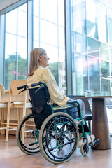 Caucasian mid aged woman on a wheelchair in a rehabilitation center