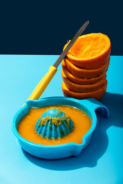 Orange juice preparation on a vivid blue background