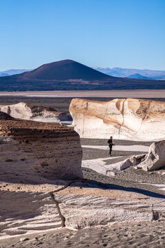 Man exploring pumice stone formations in La Puna