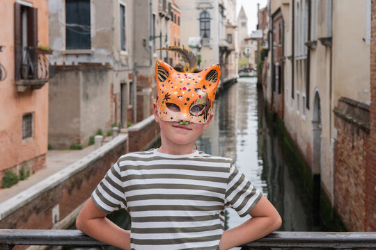 Child with colorful carnival mask in Venice