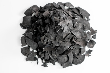 Pile of coconut shell charcoal derived from natural coconut shells