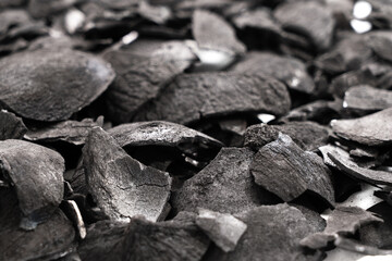 Pile of coconut shell charcoal derived from natural coconut shells
