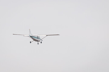 Private Airplane in Flight – Small Aircraft Landing or Taking Off in a Cloudy Blue Sky