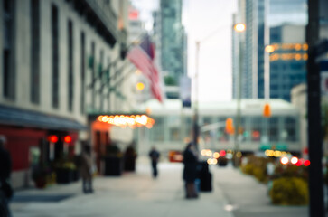 Blurred city street scene with modern urban buildings and soft bokeh lights abstract background