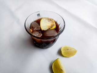 Tasty refreshing drink with coffee and lemon on white Background, space for text