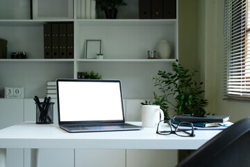 Laptop computer blank screen with clipping path on table. Workspace concept.