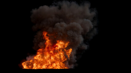 Powerful Fire with a large dark plume of dense Smoke rising high into the air and a bright fiery Orange base on a Black Background
