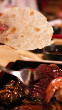 Preparing Tlayudas with Grilled Meat and Shrimp