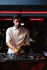 DJ performing in a nightclub with neon lights, setting the mood for a vibrant girls’ night out. Ideal for nightlife, party, and entertainment content emphasizing modern diversity and dance culture.