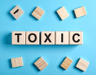 "TOXIC" Spelled with Wooden Letter Blocks