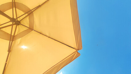 Beach umbrella on blue sky background