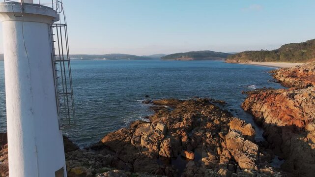 Waves Crashing In The Coastline Fazo baliza do Lago With Praia Da Barreira And Praia do Lago In Muxia, A Coru&ntilde;a, Spain. - aerial pullback shot