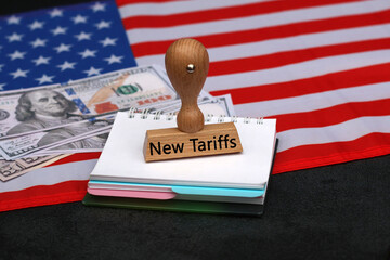 New tariffs USA: On a notepad there is a stamp with the inscription new tariffs.
