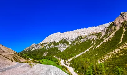 Selbstklebende Fototapeten Alpine mountain and hill landscape panorama with road Tyrol Austria. © arkadijschell