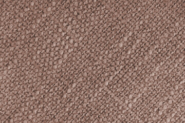 Close up, macro of brown woven fabric with detailed texture and diagonal pattern. Textile, cloth, material, fashion, upholstery, or abstract design background.
