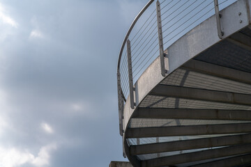 helical pedestrian ramp project in external steel, modern and innovative design staircase, for contemporary architecture. stainless steel design is designed for a pedestrian overpass in a public area.