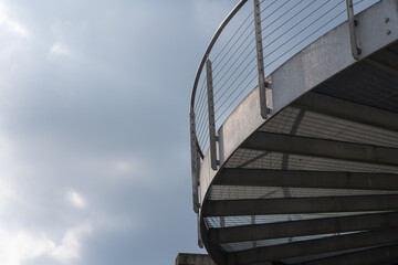 helical pedestrian ramp project in external steel, modern and innovative design staircase, for contemporary architecture. stainless steel design is designed for a pedestrian overpass in a public area.