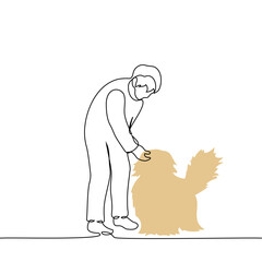 man bending over and petting a fluffy dog ​​on the head - one line art vector. concept passerby dog ​​lover, owner and pet, veterinarian and patient
