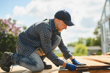 Handyman worker making patio outside close to a pool
