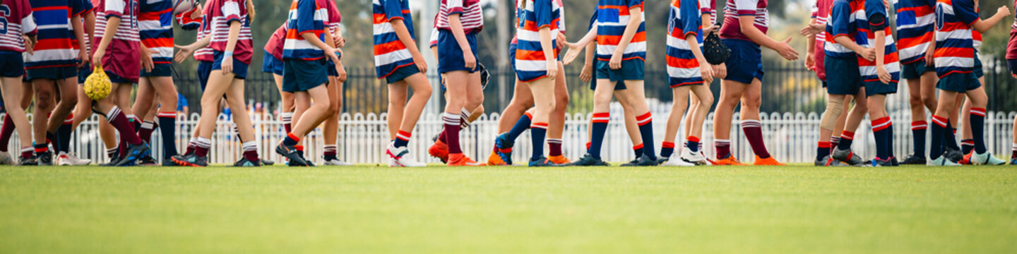Two junior rugby union teams shaking hands at the end of the match