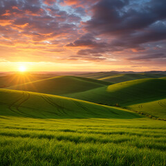 Obraz premium A spectacular sunset over rolling green hills. A breathtaking and idyllic rural landscape with vibrant fields under a colorful, dramatic sky. 