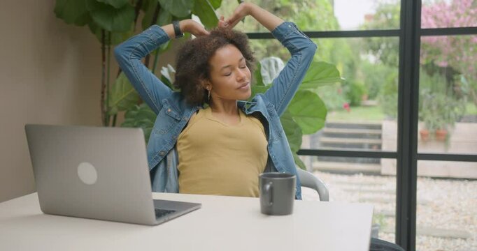 Young Adult Woman Working at Home on Laptop Technology and taking a break