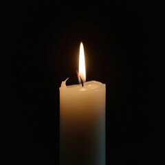 burning candle on black background