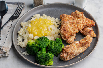 chicken tenders with mashed potatoes top with cream corn