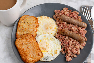 eggs ove easy  with corn beef hash and sausage