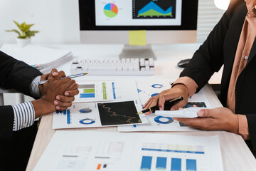 Close up of hand teamwork business group are meeting working overtime and brainstorming about business financial and marketing on paperwork and presentation.