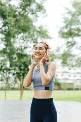 Jogging woman in athletic wear urban park fitness activity green environment dynamic viewpoint healthy lifestyle