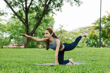 Yoga pose practice outdoor park fitness activity lush green environment side view health and wellness