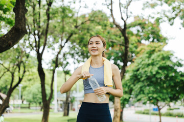 Fitness enthusiast cooling down after workout park photo greenery close-up health and wellness