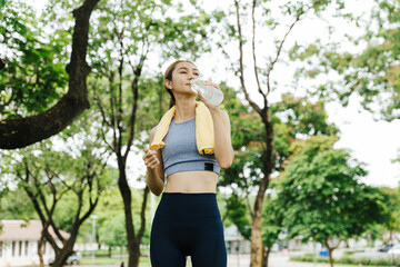 Fitness enthusiast cooling down after workout park photo greenery close-up health and wellness