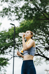 Fitness enthusiast cooling down after workout park photo greenery close-up health and wellness