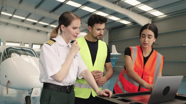 Aviation professionals discussing maintenance procedures in hangar