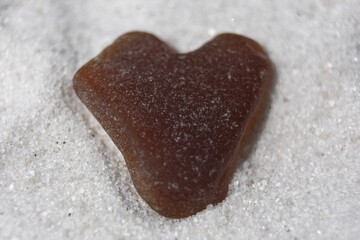 Brown Heart Shaped Beach Glass on Sand Beach