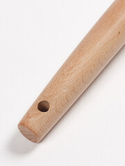 This is a close up view of a wooden stick that has a hole in the middle