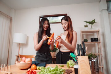 Young Women Asian Food Cooking Preparation Salad Vegetable Kitchen Lifestyle Healthy Eating, Joyful Moments of Healthy Meal Making and Togetherness in a Cozy Home Kitchen Full of Freshness and Smiles